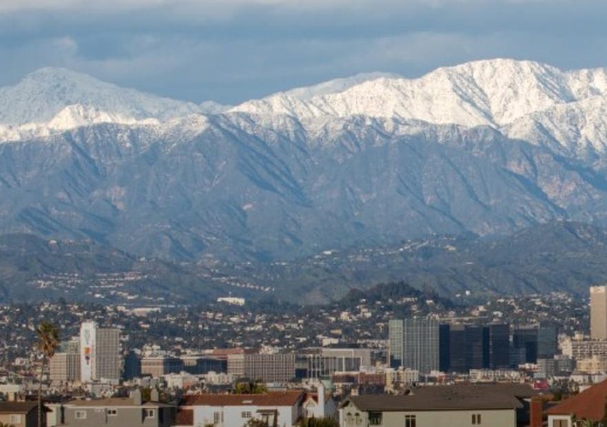 Mountains with snow in background, city in foreground 1856x619