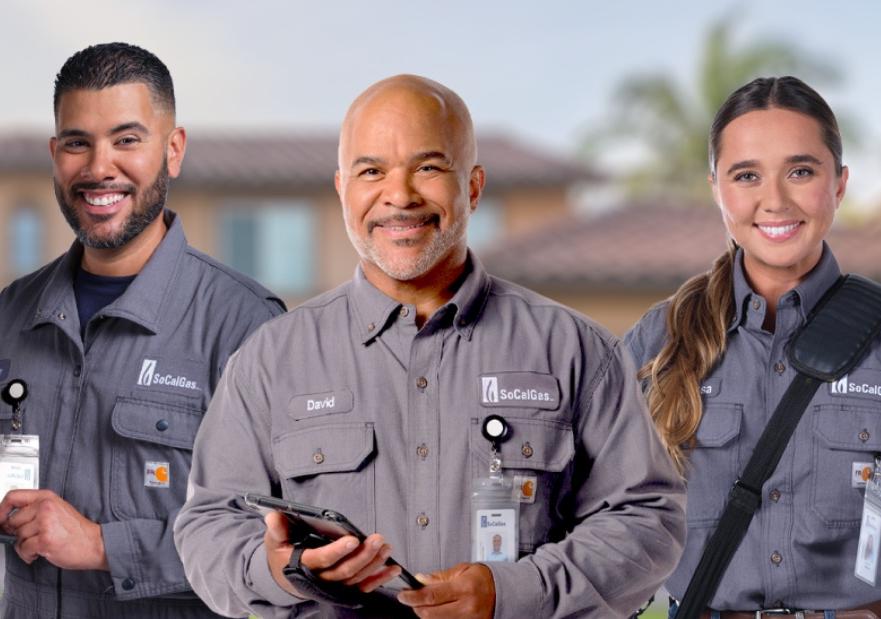 three employees wearing new uniforms